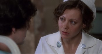 Movie still from “An American Werewolf in London” (1981), directed by John Landis – A person wearing a suit and tie; Close Up shot, Over the shoulder angle