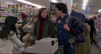 Movie still from “An American Werewolf in London” (1981), directed by John Landis – A woman and a man standing next to each other in a store; Medium shot, Over the shoulder angle