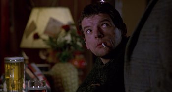 Movie still from “An American Werewolf in London” (1981), directed by John Landis – A person smoking a cigarette; Close Up shot, Over the shoulder angle