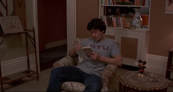 Movie still from “An American Werewolf in London” (1981), directed by John Landis – A man sitting in a chair while reading a book; Medium shot, High angle