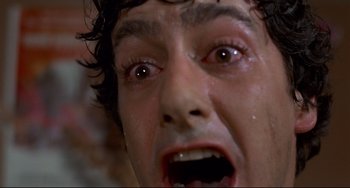 Movie still from “An American Werewolf in London” (1981), directed by John Landis – A person crying with tears coming out of their eyes; Extreme Close Up shot, Low angle