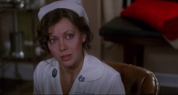 Movie still from “An American Werewolf in London” (1981), directed by John Landis – A woman wearing a nurse's uniform sitting in a chair; Close Up shot, Over the shoulder angle