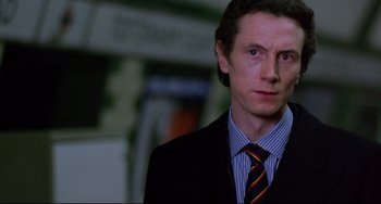 Movie still from “An American Werewolf in London” (1981), directed by John Landis – A person wearing a suit and tie; Close Up shot, Low angle