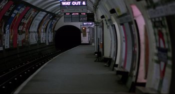 Movie still from “An American Werewolf in London” (1981), directed by John Landis – A train platform with a sign that says " way out " on it; Extreme Wide shot, High angle
