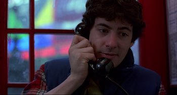 Movie still from “An American Werewolf in London” (1981), directed by John Landis – A man holding a phone up to his ear; Close Up shot, Low angle