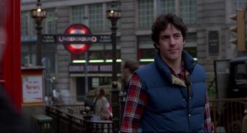 Movie still from “An American Werewolf in London” (1981), directed by John Landis – A man in a vest standing in front of a building; Medium shot, Over the shoulder angle