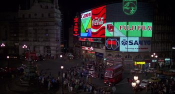 Movie still from “An American Werewolf in London” (1981), directed by John Landis – A large crowd of people on a street at night; Extreme Wide shot, High angle