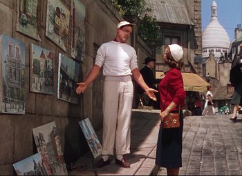 Movie still from “An American in Paris” (1951), directed by Vincente Minnelli – A man and a woman standing on the side of the street; Wide shot, Low angle