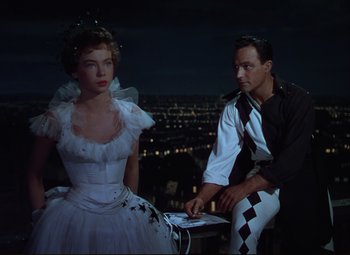 Movie still from “An American in Paris” (1951), directed by Vincente Minnelli – A man and a woman sitting in front of each other; Medium shot, High angle