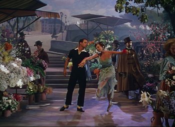 Movie still from “An American in Paris” (1951), directed by Vincente Minnelli – A man and a woman dancing in front of an audience; Wide shot, High angle