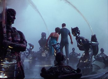 Movie still from “An American in Paris” (1951), directed by Vincente Minnelli – A man and a woman are dancing in the fog; Wide shot, Low angle