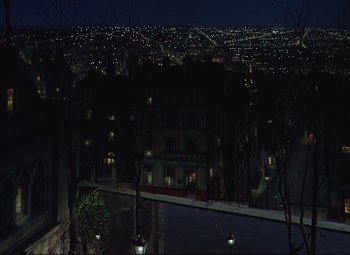 Movie still from “An American in Paris” (1951), directed by Vincente Minnelli – A view of a city at night from a balcony; Extreme Wide shot, High angle