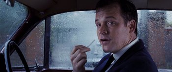 Movie still from “An Education” (2009), directed by Lone Scherfig – A person in a car holding a tooth brush; Close Up shot, Low angle