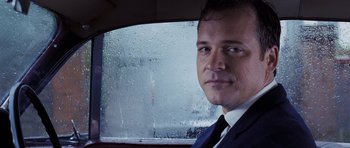 Movie still from “An Education” (2009), directed by Lone Scherfig – A person wearing a suit and tie; Close Up shot, Low angle