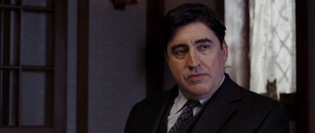 Movie still from “An Education” (2009), directed by Lone Scherfig – A person wearing a suit and tie; Close Up shot, Low angle