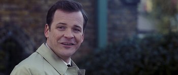 Movie still from “An Education” (2009), directed by Lone Scherfig – A person wearing a suit and tie; Close Up shot, Low angle