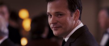 Movie still from “An Education” (2009), directed by Lone Scherfig – A person wearing a suit and tie; Close Up shot, Over the shoulder angle