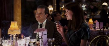 Movie still from “An Education” (2009), directed by Lone Scherfig – A man and a woman sitting at a dinner table; Medium shot, Over the shoulder angle