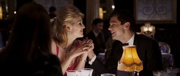 Movie still from “An Education” (2009), directed by Lone Scherfig – A man and a woman sitting at a dinner table; Medium shot, Over the shoulder angle