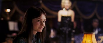 Movie still from “An Education” (2009), directed by Lone Scherfig – A young woman in front of a woman in a black dress; Close Up shot, Over the shoulder angle
