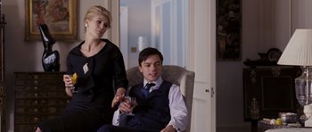Movie still from “An Education” (2009), directed by Lone Scherfig – A man and a woman are sitting in a chair; Medium shot, Over the shoulder angle
