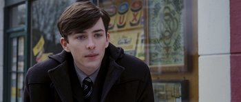 Movie still from “An Education” (2009), directed by Lone Scherfig – A young man in a black coat and a tie; Close Up shot, Over the shoulder angle
