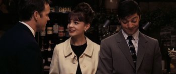 Movie still from “An Education” (2009), directed by Lone Scherfig – A woman in a white jacket and a man in a suit; Medium shot, Over the shoulder angle