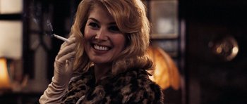 Movie still from “An Education” (2009), directed by Lone Scherfig – A woman with blonde hair wearing a leopard print coat; Close Up shot, Over the shoulder angle