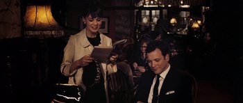 Movie still from “An Education” (2009), directed by Lone Scherfig – A man and a woman in a suit and tie; Medium shot, Over the shoulder angle