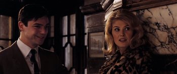 Movie still from “An Education” (2009), directed by Lone Scherfig – A woman with blonde hair wearing a leopard print scarf; Close Up shot, Over the shoulder angle