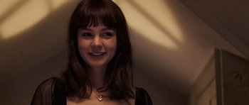Movie still from “An Education” (2009), directed by Lone Scherfig – A young woman smiles for the camera; Close Up shot, Over the shoulder angle