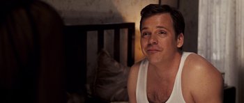 Movie still from “An Education” (2009), directed by Lone Scherfig – A person sitting on a bed near a cat; Close Up shot, Over the shoulder angle