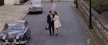 Movie still from “An Education” (2009), directed by Lone Scherfig – A man and a woman walking down a street; Wide shot, High angle