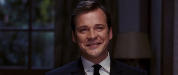 Movie still from “An Education” (2009), directed by Lone Scherfig – A person wearing a suit and tie; Close Up shot, Low angle