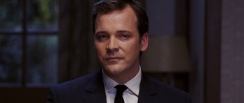 Movie still from “An Education” (2009), directed by Lone Scherfig – A person wearing a suit and tie; Close Up shot, Low angle