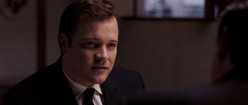 Movie still from “An Education” (2009), directed by Lone Scherfig – A person wearing a suit and tie; Close Up shot, Over the shoulder angle