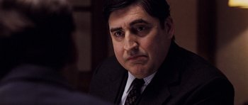 Movie still from “An Education” (2009), directed by Lone Scherfig – A person wearing a suit and tie; Close Up shot, Over the shoulder angle