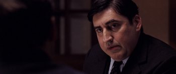 Movie still from “An Education” (2009), directed by Lone Scherfig – A person wearing a suit and tie; Close Up shot, Over the shoulder angle