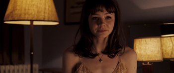 Movie still from “An Education” (2009), directed by Lone Scherfig – A young woman with long brown hair wearing a yellow dress; Close Up shot, Over the shoulder angle