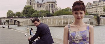 Movie still from “An Education” (2009), directed by Lone Scherfig – A man and a woman riding a motorcycle down a river; Medium shot, Over the shoulder angle