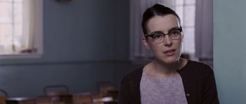 Movie still from “An Education” (2009), directed by Lone Scherfig – A woman wearing glasses and a sweater looking to her left; Close Up shot, Over the shoulder angle