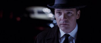 Movie still from “An Education” (2009), directed by Lone Scherfig – A person wearing a suit and hat; Close Up shot, Over the shoulder angle