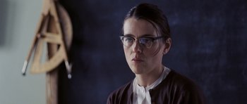 Movie still from “An Education” (2009), directed by Lone Scherfig – A woman wearing glasses looking at the camera; Close Up shot, Over the shoulder angle