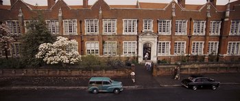 Movie still from “An Education” (2009), directed by Lone Scherfig – An old car parked on the side of the street; Extreme Wide shot, High angle