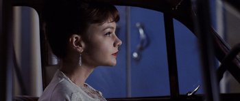 Movie still from “An Education” (2009), directed by Lone Scherfig – A young woman looking out of a car window; Close Up shot, Over the shoulder angle