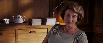 Movie still from “An Education” (2009), directed by Lone Scherfig – An older woman wearing a dress and a necklace; Close Up shot, Over the shoulder angle