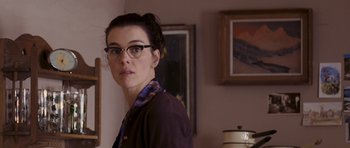 Movie still from “An Education” (2009), directed by Lone Scherfig – A woman with glasses standing in front of a wall; Close Up shot, Over the shoulder angle