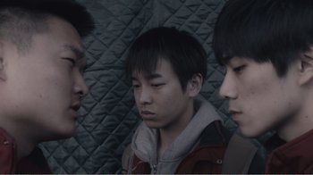 Movie still from “An Elephant Sitting Still” (2018), directed by Bo Hu – A group of young men standing next to each other; Close Up shot, Low angle