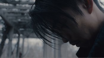 Movie still from “An Elephant Sitting Still” (2018), directed by Bo Hu – A person's face with long black hair; Close Up shot, Low angle