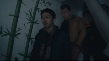 Movie still from “An Elephant Sitting Still” (2018), directed by Bo Hu – Two men standing next to each other in a room; Medium shot, Low angle